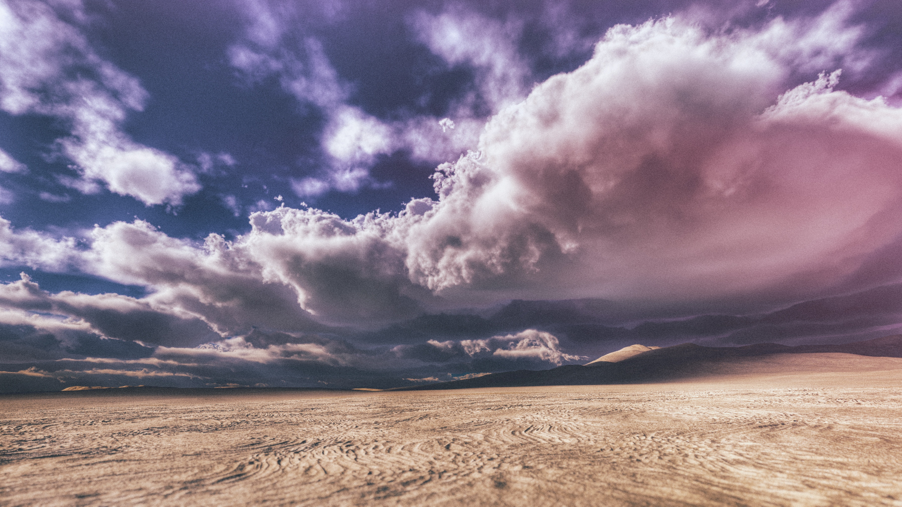 Purple clouds above a baron desert